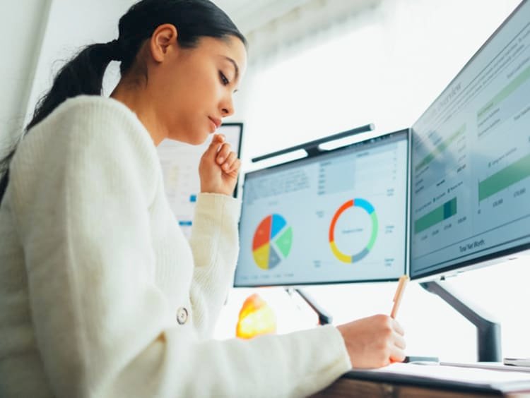 Student sitting with laptop and notebook learning accounting basics step by step